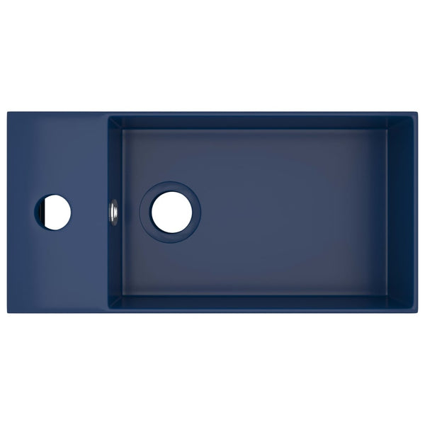 Tummansininen kylpyhuoneen pesuallas ylivuodolla keraaminen Amina