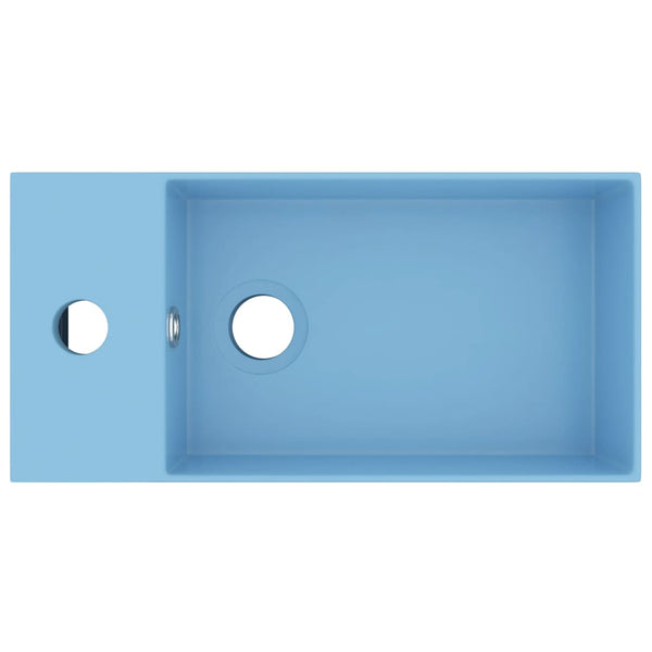 Vaaleansin kylpyhuoneen pesuallas ylivuodolla keraaminen Amina