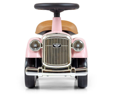 Vaaleanpunainen leikkiauto lapsille, jossa on Rolls Royce -merkki.