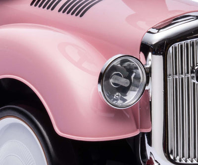 Vaaleanpunainen leikkiauto Rolls-Royce -merkillä.