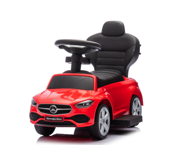 Punainen metallinen lasten ajettava auto rullilla ja työntöaisalla