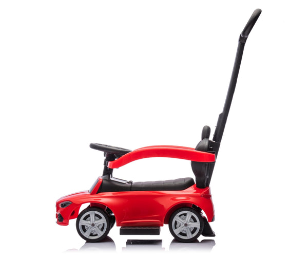Punainen metallinen lasten ajettava auto rullilla ja työntöaisalla