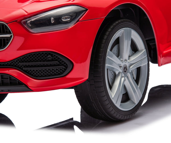 Punainen metallinen lasten ajettava auto rullilla ja työntöaisalla