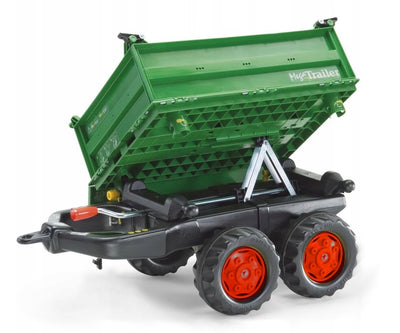 Rolly Toysin tummanvihreä kahden akselin perävaunu, jossa on suuret renkaat.