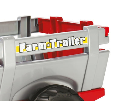 Punainen Rolly Toys 811397 traktori junior RT -malleissa on perävaunu ja lapiokauha.