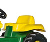 Punainen Rolly Toys -traktori Junior John Deere -logoilla, mukana kauha ja peräkärry.