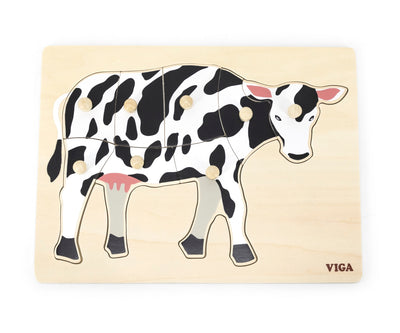 Puzzle, jossa on kuvioitu lehmä ja kahvoilla varustettu alusta.