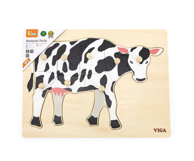 Puzzle-tuote, joka koostuu kuvasta kohokuvioituna alustalle, jossa on kahvat. Teemana on lehmä.