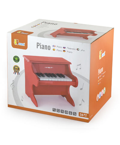 Kuva puusta valmistetusta leikkimielisestä pianosta, jossa on erivärisiä koskettimia ja nuottiteline.