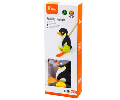 Puinen pingviini-lelu, jossa on punaiset ja valkoiset värit.